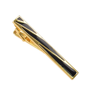 Gold-tone tie clip featuring geometric black enamel inlay and a hinged clip back