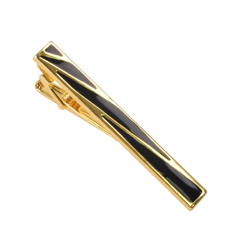 Gold-tone tie clip featuring geometric black enamel inlay and a hinged clip back
