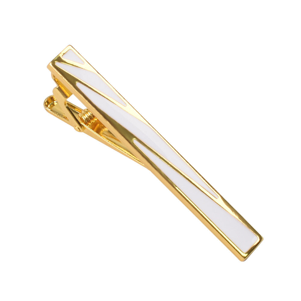 Gold-tone metal tie clip featuring geometric white enamel inlay and a spring hinge clasp.