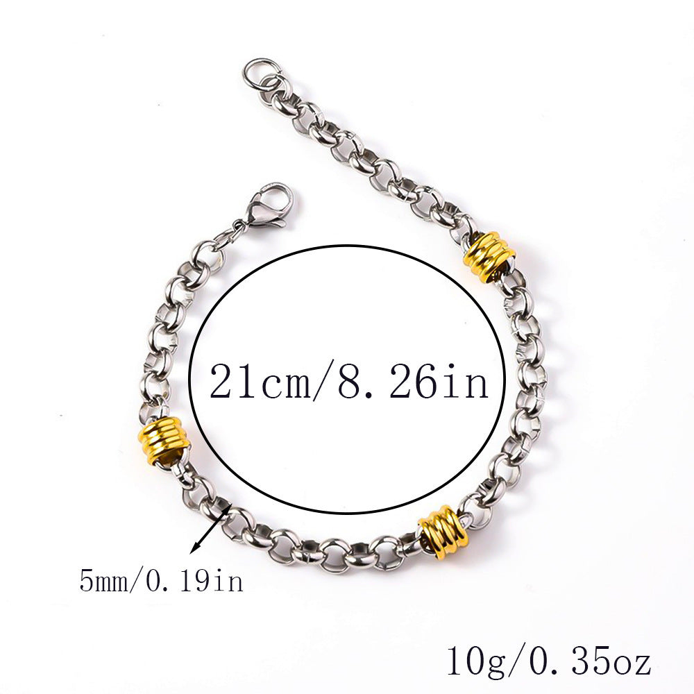 Silver-tone rolo chain bracelet featuring segmented gold-tone barrel accents and a lobster clasp