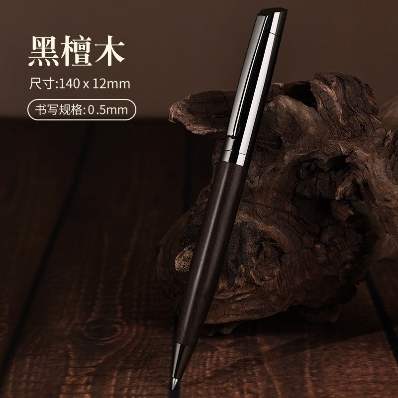 A pen with a dark sandalwood barrel and polished gunmetal cap and trim.