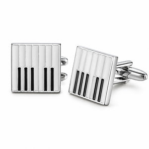 A pair of square silver-tone cufflinks with a black and white piano key enamel pattern and a hinged T-bar toggle