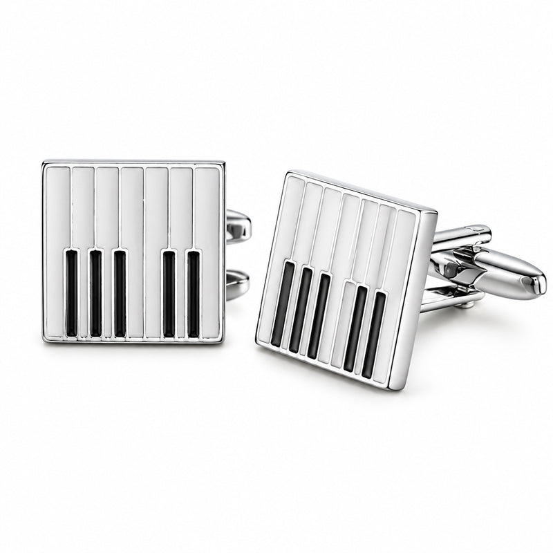 A pair of square silver-tone cufflinks with a black and white piano key enamel pattern and a hinged T-bar toggle