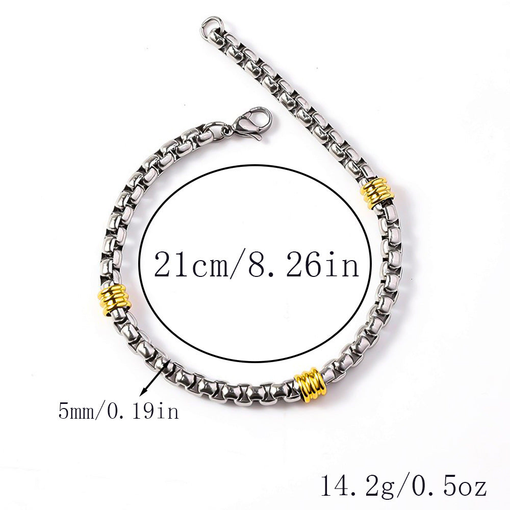 Silver-tone box chain bracelet featuring three gold-tone ribbed spacer stations and a lobster clasp