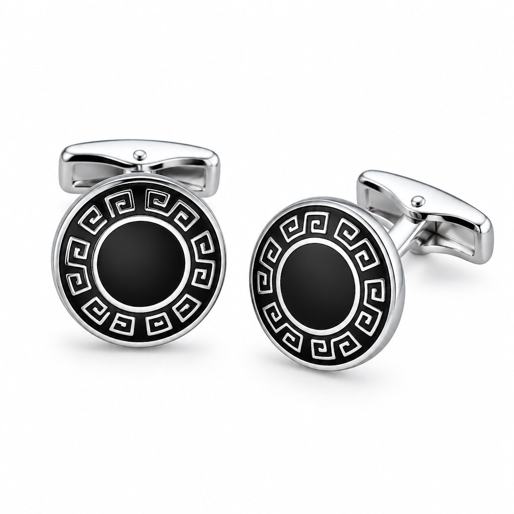 A pair of silver-tone cufflinks featuring a black enamel Greek key border and a solid dark centre.