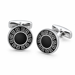 A pair of silver-tone cufflinks featuring a black enamel Greek key border and a solid dark centre.