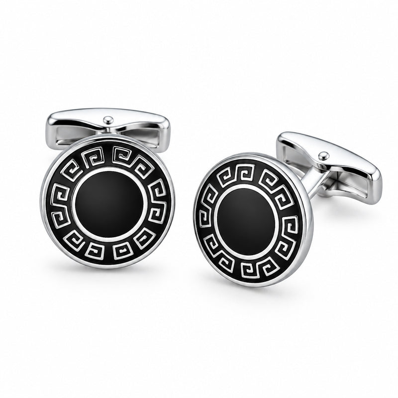 A pair of silver-tone cufflinks featuring a black enamel Greek key border and a solid dark centre.
