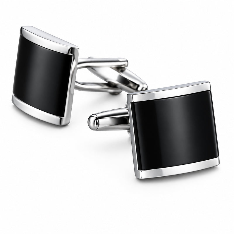 Silver-tone cufflinks featuring a curved black enamel insert inside a polished metal frame with a hinged T-bar fastening