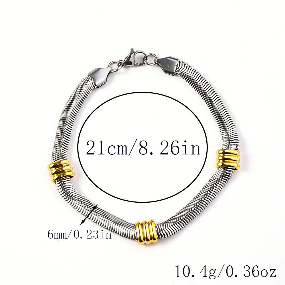 Silver-tone snake chain bracelet featuring three polished gold-tone ring accents and a lobster clasp