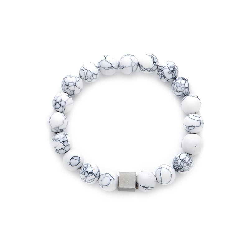 White marble-effect beaded bracelet with a central matte silver-tone cube bead on a white background