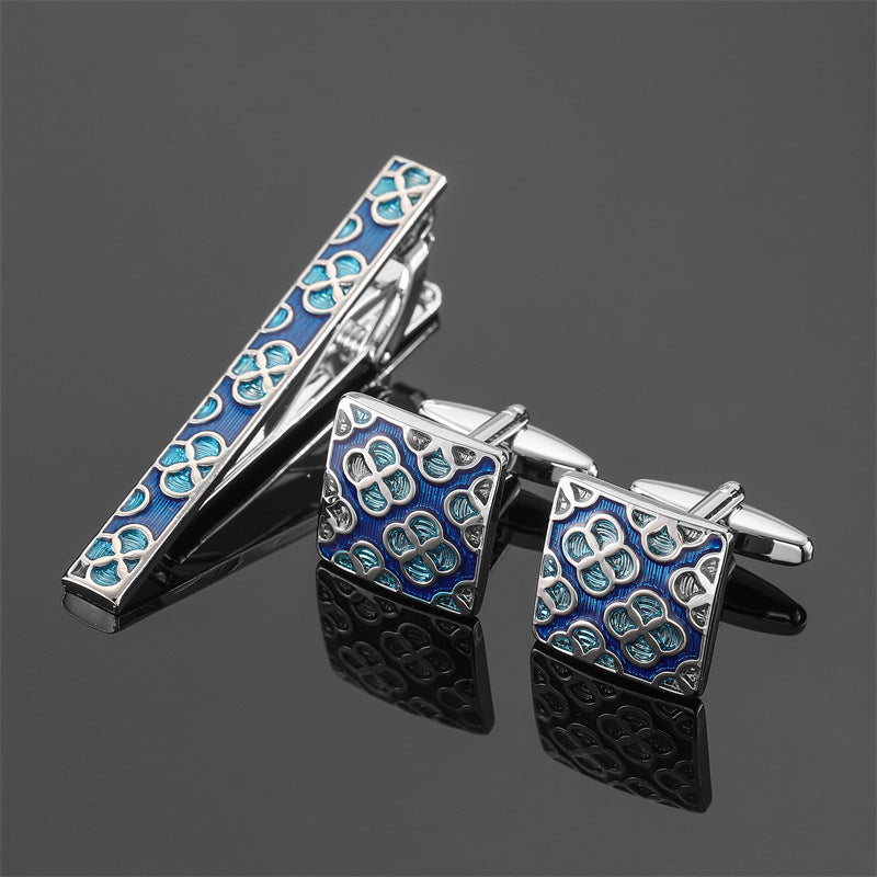 Silver-tone tie clip and square cufflinks featuring a blue enamel quatrefoil pattern