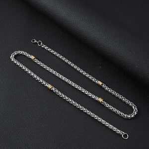Silver-tone wheat chain necklace featuring alternating gold-tone steel ring accents and a round spring clasp.