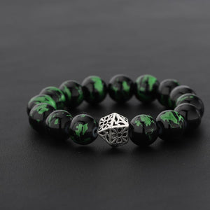 Men's black and green beaded bracelet featuring a silver-tone openwork geometric center bead