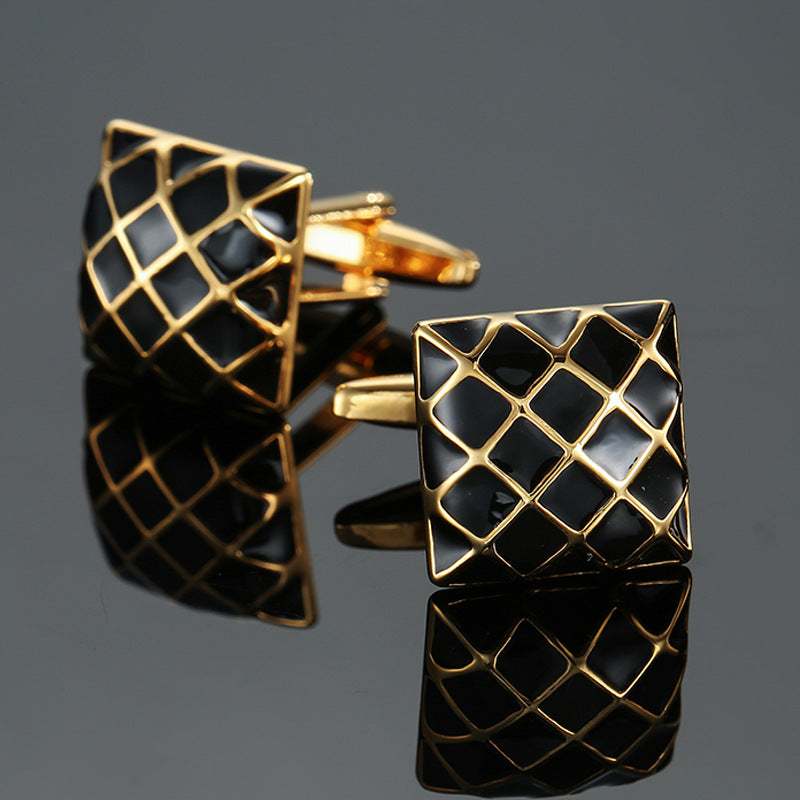 A pair of square gold-tone cufflinks with a black enamel quilted grid pattern and swivel bar closures.