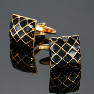 A pair of square gold-tone cufflinks with a black enamel quilted grid pattern and swivel bar closures.