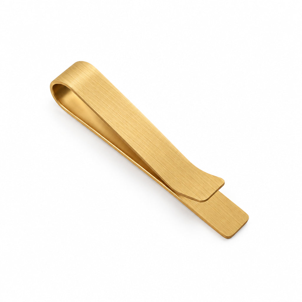 Gold-tone stainless steel tie-clip with a brushed finish and a flared end
