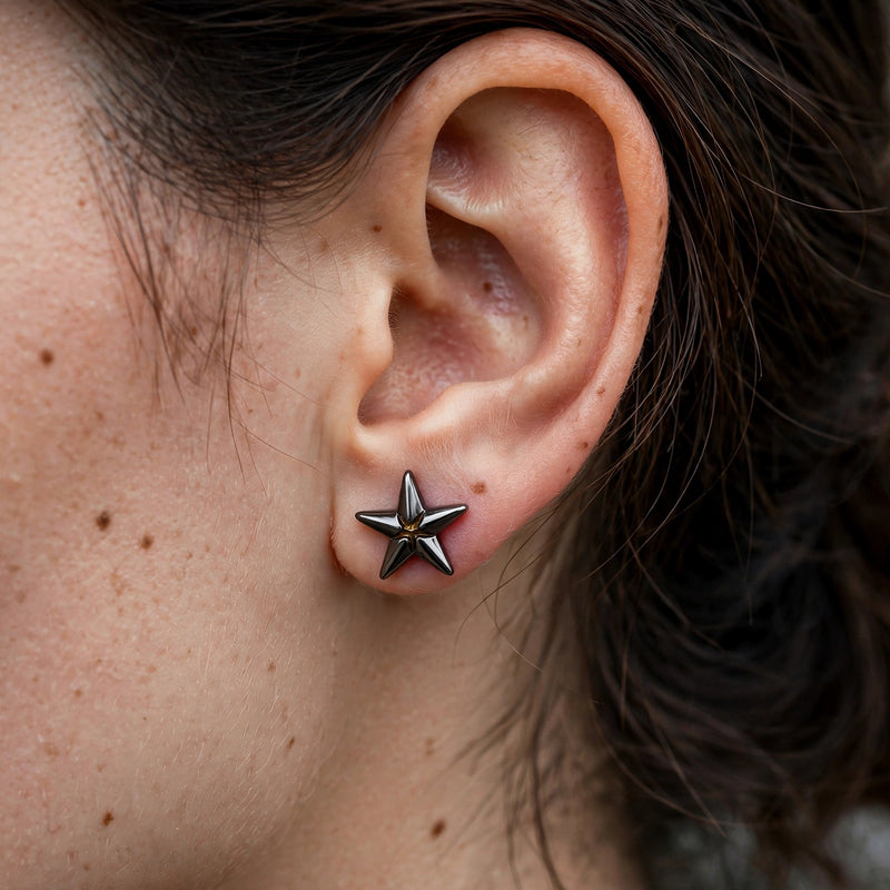 Black Star-Shaped Stud Earrings with Stone Centre - worn on model