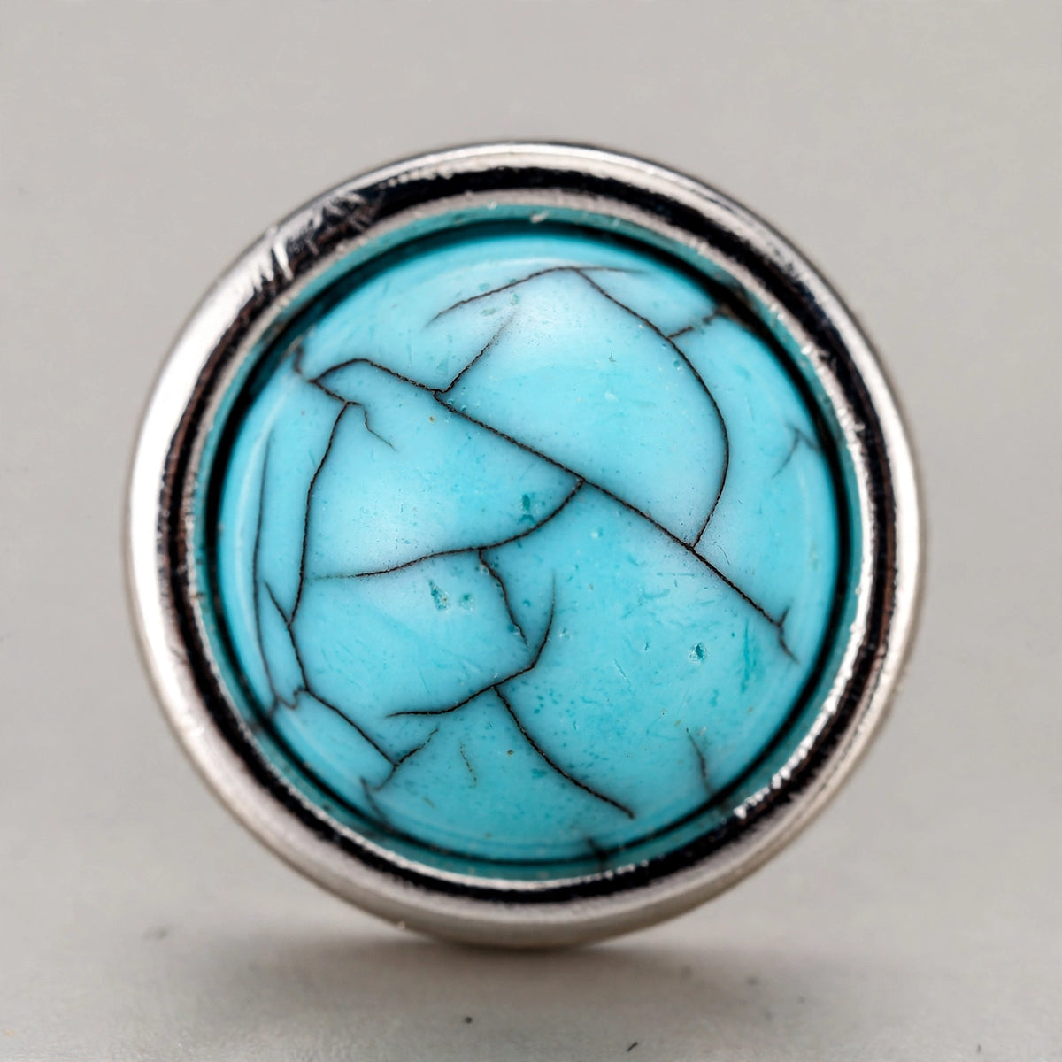 Turquoise Stone Stud Earrings with Polished Silver-Tone Border - close-up detail